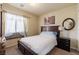 Cozy bedroom with neutral walls, carpeted floor, a full size bed and a bright window at 6705 Philharmonic Ave, Las Vegas, NV 89139
