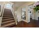 Hallway with a carpeted staircase, wood floors, and transom window at 6705 Philharmonic Ave, Las Vegas, NV 89139