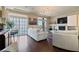Well lit living room with fireplace, hardwood floors, and sliding door access to balcony at 6705 Philharmonic Ave, Las Vegas, NV 89139