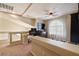 Loft area featuring neutral carpeting, a ceiling fan, and a built-in desk area at 6705 Philharmonic Ave, Las Vegas, NV 89139