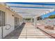 A covered back patio has a brick fire pit and concrete flooring at 6808 Waterhen Cir, Las Vegas, NV 89108