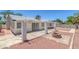 An open backyard has a brick fire pit and a covered back patio at 6808 Waterhen Cir, Las Vegas, NV 89108