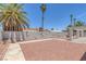 The backyard has palm trees and a concrete perimeter at 6808 Waterhen Cir, Las Vegas, NV 89108