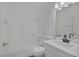 Clean bathroom featuring a shower-tub combo and single sink vanity with modern faucet and lighting at 6808 Waterhen Cir, Las Vegas, NV 89108