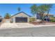 Charming single-story home showcasing a well-manicured front yard, a two-car garage, and desert landscaping at 6808 Waterhen Cir, Las Vegas, NV 89108