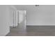 Bright living room featuring new gray flooring, neutral paint, and doorways at 6808 Waterhen Cir, Las Vegas, NV 89108