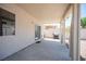 Covered back patio with a sliding glass door, a barbecue grill, and a neutral color scheme at 7021 Salt Marsh Ct, Las Vegas, NV 89148