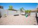 Spacious backyard featuring desert landscaping, a block wall, and a playset with slide and swings at 7021 Salt Marsh Ct, Las Vegas, NV 89148