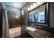 The bathroom features dark cabinets, granite counters, a shower with unique tile, and decorative shower curtain at 7021 Salt Marsh Ct, Las Vegas, NV 89148