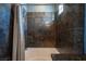 This bathroom has a stylish tile shower with a rain shower head and a neutral-colored shower curtain at 7021 Salt Marsh Ct, Las Vegas, NV 89148