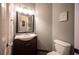Powder room featuring vanity with dark wood cabinet and a toilet at 7021 Salt Marsh Ct, Las Vegas, NV 89148