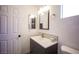 Bathroom featuring sink, toilet, and a large mirror at 7021 Salt Marsh Ct, Las Vegas, NV 89148