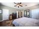 This bedroom features hardwood floors, a ceiling fan, and multiple closets and doors to other rooms at 7021 Salt Marsh Ct, Las Vegas, NV 89148