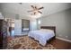 Hardwood flooring, overhead fan, king bed, and multiple closets are the highlights of this bedroom at 7021 Salt Marsh Ct, Las Vegas, NV 89148