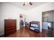 Bright bedroom featuring hardwood floors, closet space, and a ceiling fan at 7021 Salt Marsh Ct, Las Vegas, NV 89148