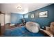 Spacious bonus room with fitness equipment, blue accent wall, and hardwood floors at 7021 Salt Marsh Ct, Las Vegas, NV 89148