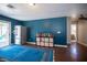 Bonus room featuring sliding glass doors, a refrigerator, and blue walls at 7021 Salt Marsh Ct, Las Vegas, NV 89148