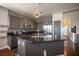 This kitchen features granite countertops, a mosaic backsplash, gray cabinets, and stainless steel appliances at 7021 Salt Marsh Ct, Las Vegas, NV 89148
