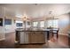 Modern kitchen with stainless steel appliances and granite countertops open to living area at 7021 Salt Marsh Ct, Las Vegas, NV 89148