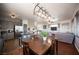 Open-concept living and dining area with tile floors and modern kitchen with stainless appliances at 7021 Salt Marsh Ct, Las Vegas, NV 89148