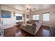 Spacious living room featuring hardwood floors, a ceiling fan, and a large sectional sofa at 7021 Salt Marsh Ct, Las Vegas, NV 89148