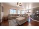 Spacious living room featuring hardwood floors, a ceiling fan, and a large sectional sofa at 7021 Salt Marsh Ct, Las Vegas, NV 89148