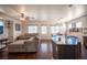 Spacious living room featuring hardwood floors, a ceiling fan, and a large sectional sofa at 7021 Salt Marsh Ct, Las Vegas, NV 89148