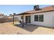 Backyard includes patio with table and chairs and a wall for privacy at 7144 Forest Vista St, Las Vegas, NV 89147
