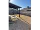 View of the backyard featuring gravel landscaping, a covered patio, and block wall fence at 7144 Forest Vista St, Las Vegas, NV 89147