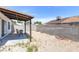 Backyard with privacy wall has a small patio set and is xeriscaped with gravel at 7144 Forest Vista St, Las Vegas, NV 89147