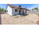 Spacious backyard with desert landscaping features covered patio and privacy walls at 7144 Forest Vista St, Las Vegas, NV 89147