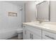 Modern bathroom features a white vanity, chrome fixtures, and tiled shower and tub at 7144 Forest Vista St, Las Vegas, NV 89147