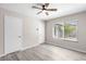 Bright bedroom with wood-look flooring, neutral paint and a ceiling fan at 7144 Forest Vista St, Las Vegas, NV 89147
