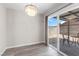 A modern dining area with a decorative light fixture and sliding door access to the backyard at 7144 Forest Vista St, Las Vegas, NV 89147