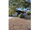 Front yard with gravel landscaping, large shade tree, and view of the home's exterior at 7144 Forest Vista St, Las Vegas, NV 89147