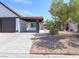 Home with desert landscaping, a covered carport and mature trees at 7144 Forest Vista St, Las Vegas, NV 89147