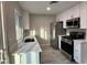 Modern kitchen features white cabinets, stainless steel appliances, and light countertops at 7144 Forest Vista St, Las Vegas, NV 89147