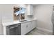 Updated kitchen with white cabinetry, stainless appliances, and light counter tops near the sink at 7144 Forest Vista St, Las Vegas, NV 89147