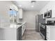 Modern kitchen features white cabinets, stainless steel appliances, and light countertops and tiled backsplash at 7144 Forest Vista St, Las Vegas, NV 89147