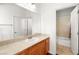 Well-lit bathroom featuring granite counters, a large mirror, and a bathtub with shower at 7258 Sashaying Spirit Ct, Las Vegas, NV 89131