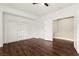Bright bedroom with dark wood floor, large closet, and fresh white walls at 7258 Sashaying Spirit Ct, Las Vegas, NV 89131