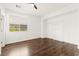 Bright bedroom with wood floors, large window, and decorative shelving at 7258 Sashaying Spirit Ct, Las Vegas, NV 89131