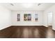 Well-lit bedroom with wood-look floors and three windows showcasing neighborhood at 7258 Sashaying Spirit Ct, Las Vegas, NV 89131