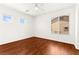 Bright bedroom featuring pristine white walls, hardwood floors, and a ceiling fan for added comfort at 7258 Sashaying Spirit Ct, Las Vegas, NV 89131