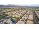 Aerial view showcasing community pool and playground with residential area, mountains in the background at 7559 Chimney Point Ct, Las Vegas, NV 89166