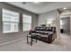 Living room with neutral walls, carpet, windows, a sofa, and a small table at 7559 Chimney Point Ct, Las Vegas, NV 89166