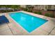 Sparkling community pool surrounded by a concrete deck and lounge chairs at 7559 Chimney Point Ct, Las Vegas, NV 89166