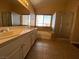 Bathroom featuring double sinks, tile flooring, and a separate shower and bathtub at 7604 Cruz Bay Ct, Las Vegas, NV 89128