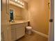 Clean powder bathroom with vanity, toilet, and tile flooring at 7604 Cruz Bay Ct, Las Vegas, NV 89128