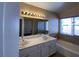 Well-lit bathroom with double sinks, tile flooring, and a separate shower and bathtub at 7604 Cruz Bay Ct, Las Vegas, NV 89128